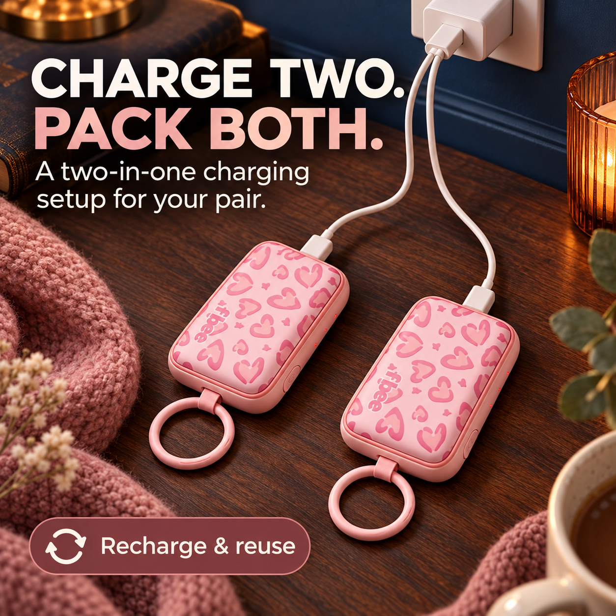 Two rechargeable hand warmers connected to a split charging cable