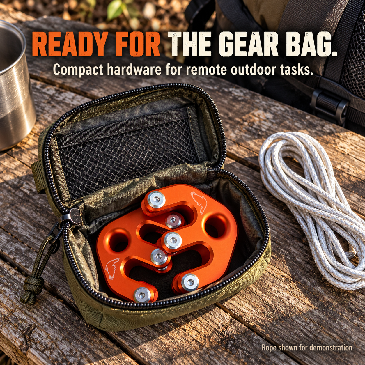 Compact orange hoist hardware packed in a small outdoor gear pouch
