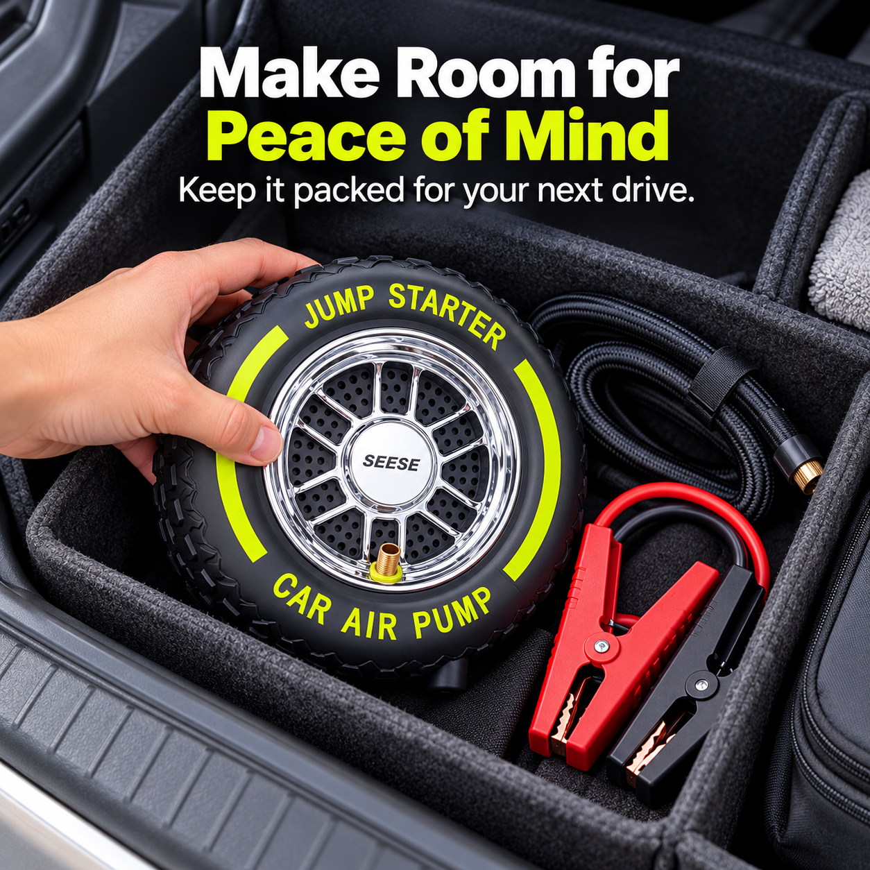 Tire-shaped portable inflator and jump starter with hose and battery clamps in a car trunk organizer
