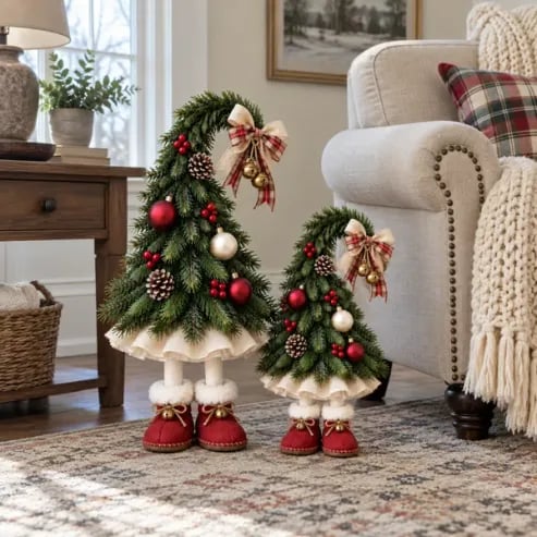 Christmas elf tree decorations styled beside a cozy living room armchair