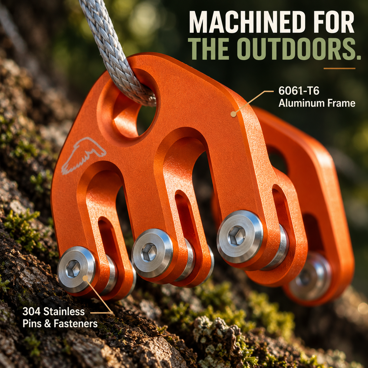 Close-up of orange machined aluminum hoist block and stainless steel hardware